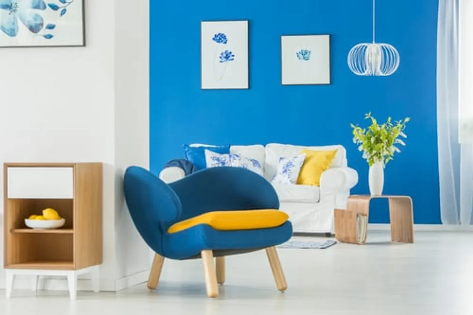 Freshly painted living room with a deep blue accent wall and crisp white trim